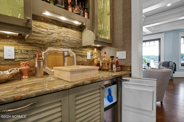 bar with dishwasher, sink, crown molding, light stone countertops, and dark hardwood / wood-style floors