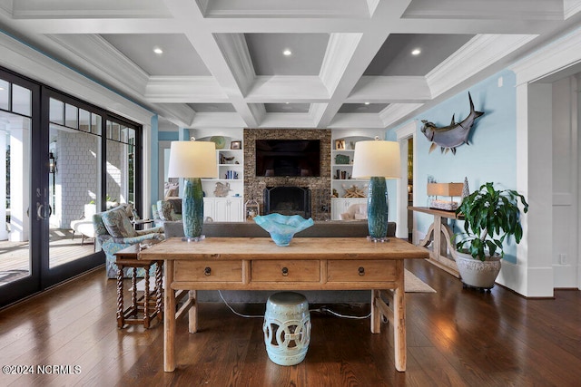 living room featuring coffered ceiling, dark hardwood / wood-style flooring, and a fireplace