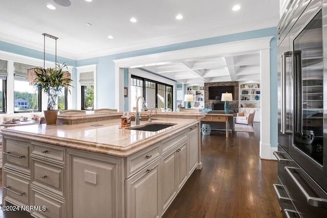 kitchen featuring pendant lighting, coffered ceiling, dark hardwood / wood-style flooring, high quality fridge, and crown molding