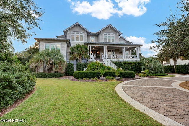 view of front of house featuring a front yard and a porch