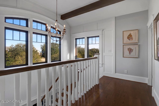 hallway featuring a chandelier, dark hardwood / wood-style floors, and lofted ceiling with beams