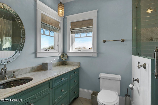 bathroom featuring toilet, tile floors, and large vanity