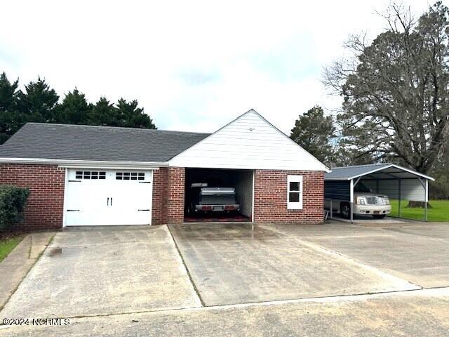 view of front facade featuring a carport and a garage