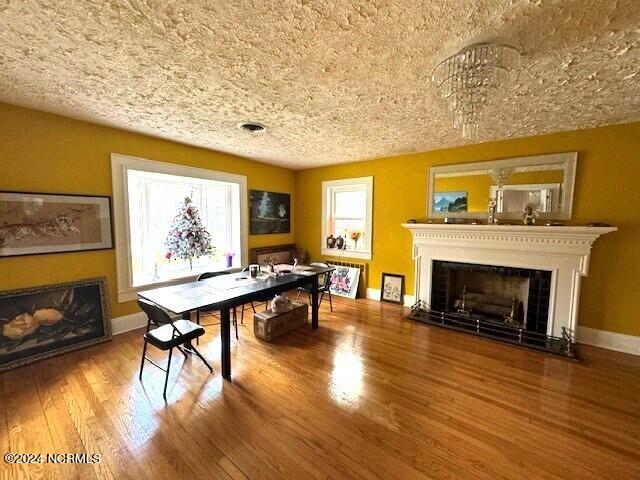 dining area featuring a textured ceiling and wood-type flooring