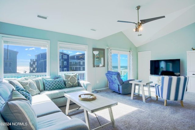 living room with ceiling fan, carpet floors, and lofted ceiling