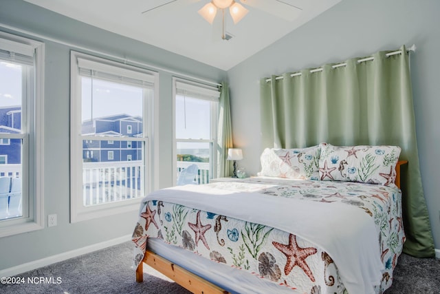 bedroom with carpet flooring, ceiling fan, lofted ceiling, and multiple windows