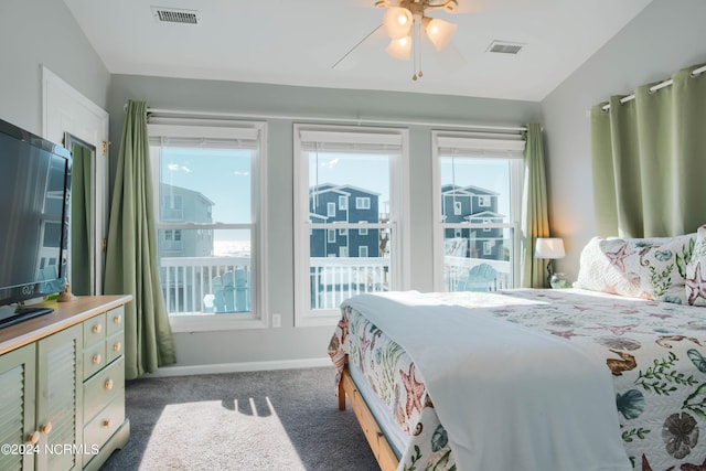 carpeted bedroom with ceiling fan and lofted ceiling