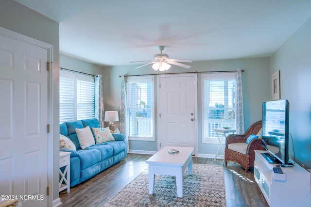 living room featuring dark hardwood / wood-style floors and ceiling fan