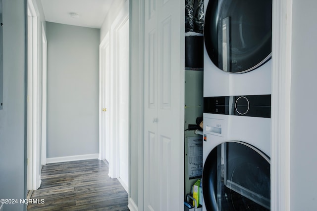 clothes washing area with stacked washer / dryer and dark hardwood / wood-style floors