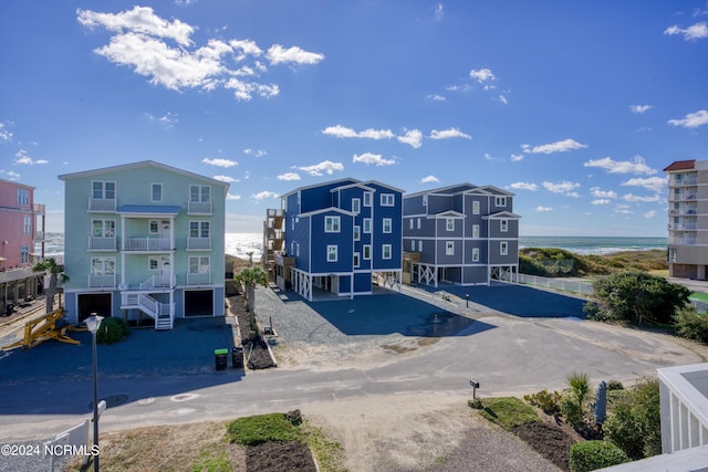 view of building exterior featuring a water view and a garage