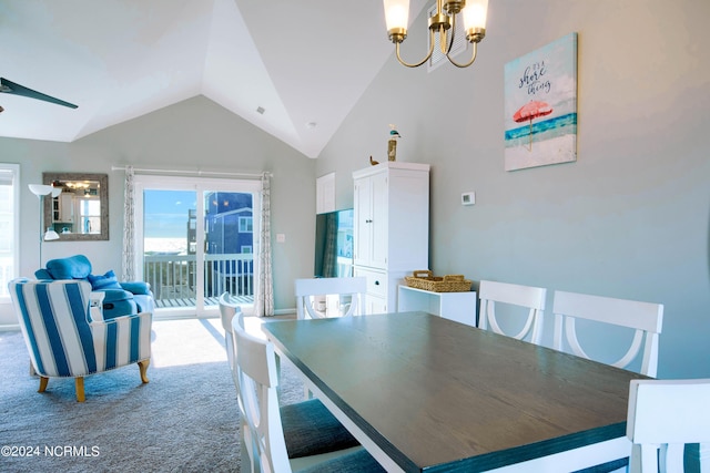 dining area with carpet flooring, ceiling fan with notable chandelier, and lofted ceiling