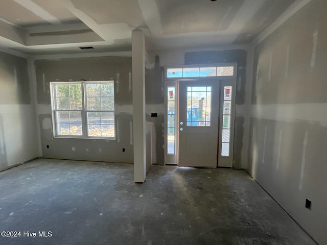 entrance foyer featuring visible vents and a tray ceiling