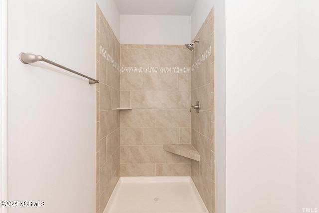 bathroom with a tile shower