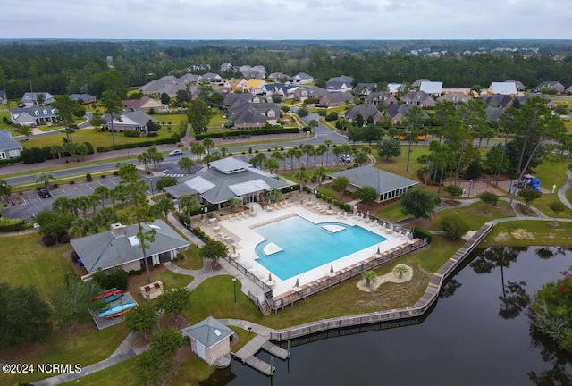 drone / aerial view with a residential view and a water view