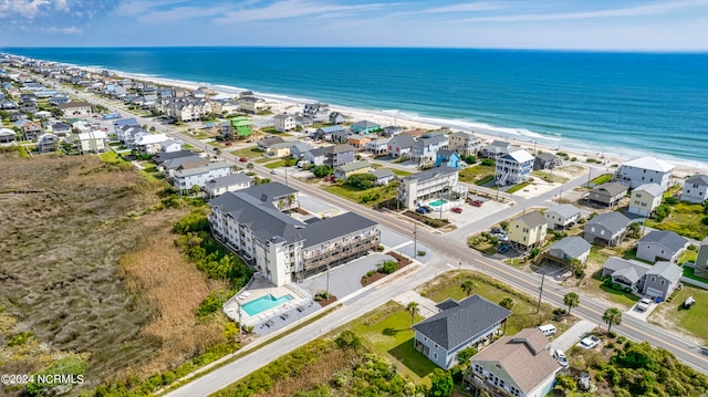 birds eye view of property with a water view and a view of the beach