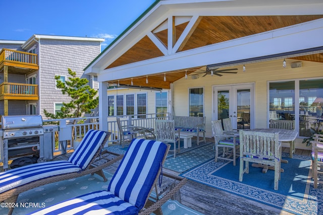 wooden terrace featuring ceiling fan, french doors, and a grill