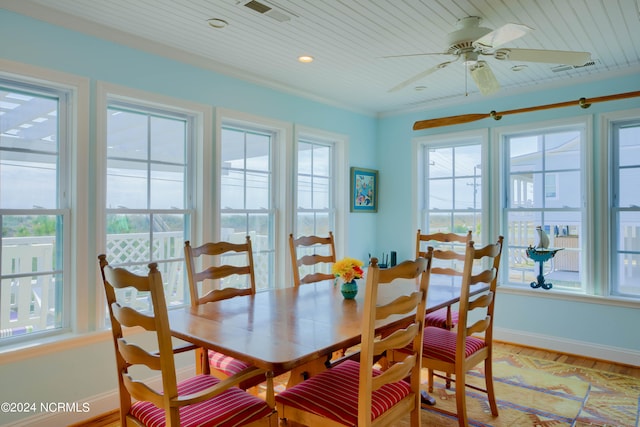 dining space with ceiling fan, crown molding, hardwood / wood-style floors, and a wealth of natural light