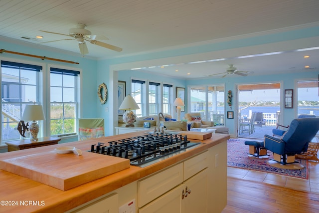 kitchen featuring light wood-type flooring, a healthy amount of sunlight, butcher block countertops, and ceiling fan