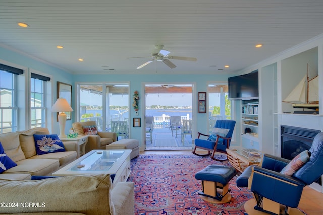 living room with ornamental molding and ceiling fan