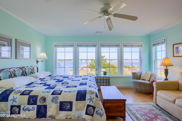 bedroom featuring ceiling fan, hardwood / wood-style flooring, and crown molding