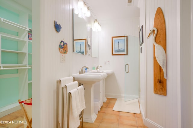 bathroom with walk in shower and tile patterned floors