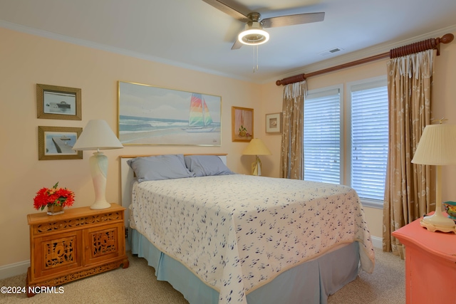 bedroom with ornamental molding, ceiling fan, and light carpet