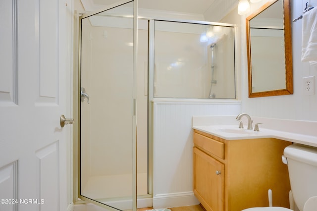 bathroom with ornamental molding, vanity, toilet, and an enclosed shower