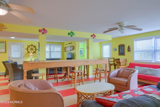 living room with a healthy amount of sunlight and ceiling fan