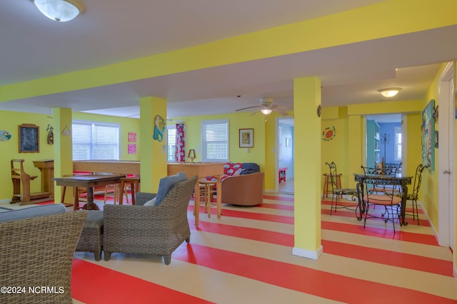 interior space with ceiling fan