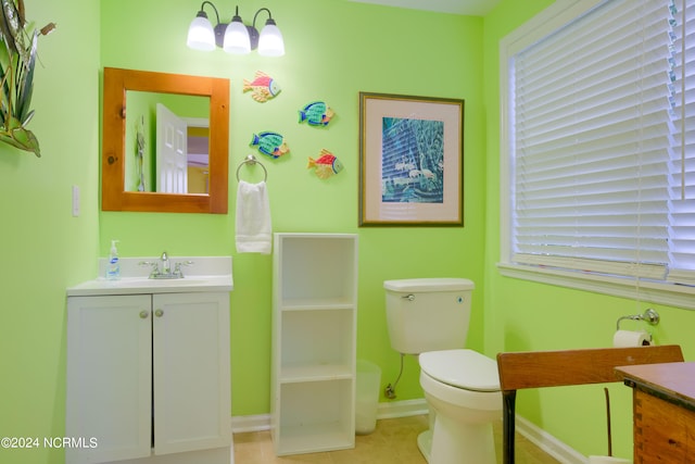 bathroom featuring vanity, tile patterned flooring, and toilet