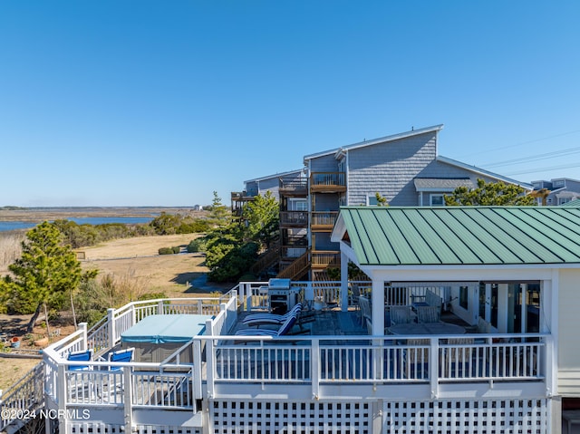 exterior space with a deck with water view