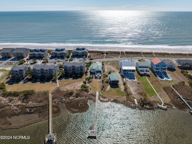 drone / aerial view featuring a water view and a view of the beach