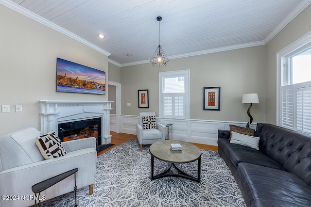 living room with hardwood / wood-style flooring, crown molding, and a healthy amount of sunlight