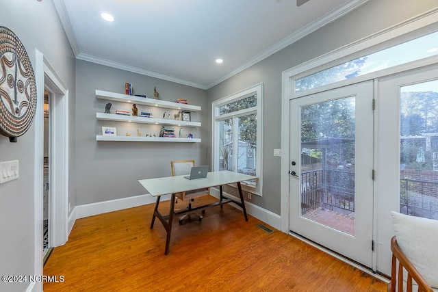 home office with wood-type flooring, crown molding, and a wealth of natural light