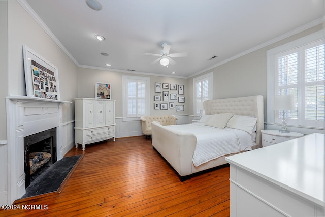 bedroom with ceiling fan, crown molding, and hardwood / wood-style floors