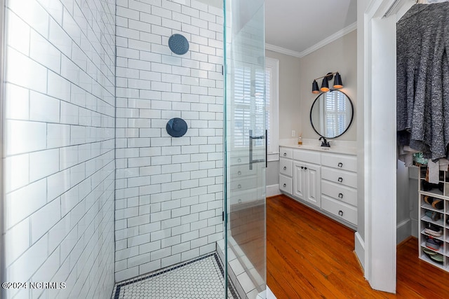 bathroom featuring vanity, hardwood / wood-style flooring, and tiled shower