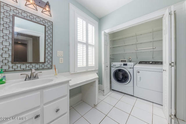 laundry room featuring washing machine and dryer, light tile patterned flooring, and sink