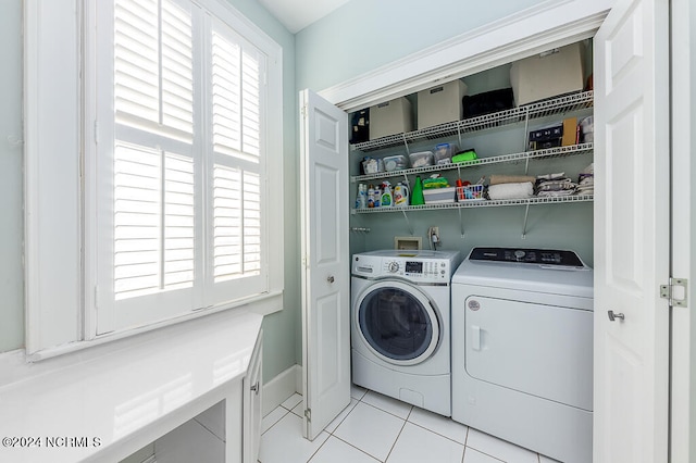 laundry room with separate washer and dryer and light tile patterned floors