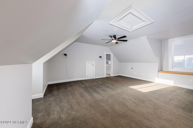 bonus room featuring lofted ceiling, dark colored carpet, and ceiling fan