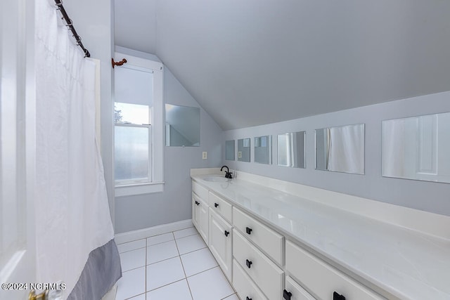 bathroom with lofted ceiling, vanity, and tile patterned floors