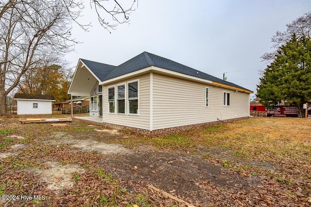 view of home's exterior featuring a storage unit and a wooden deck