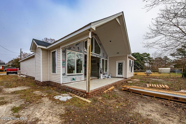 back of property with a patio