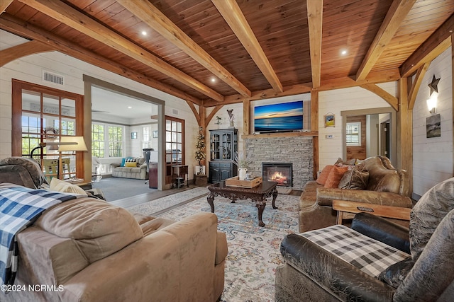 living room featuring a fireplace, wood ceiling, beamed ceiling, and carpet flooring