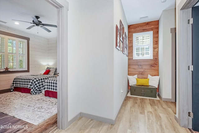 interior space featuring wooden walls and light wood-type flooring