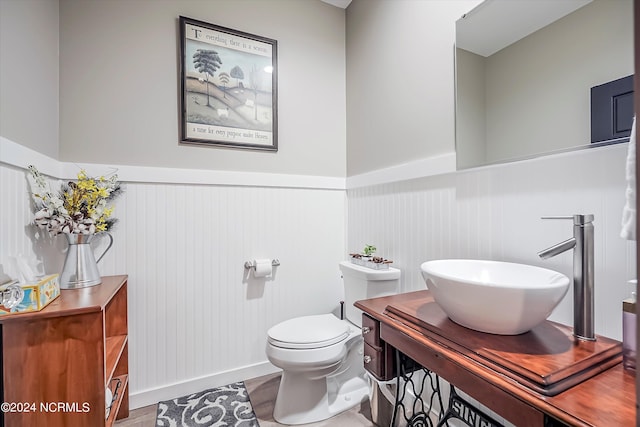 bathroom with hardwood / wood-style floors, oversized vanity, and toilet