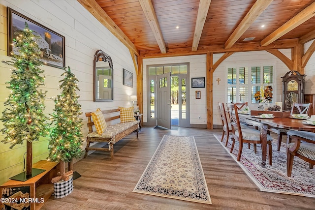 interior space with light hardwood / wood-style floors, wood ceiling, and beamed ceiling