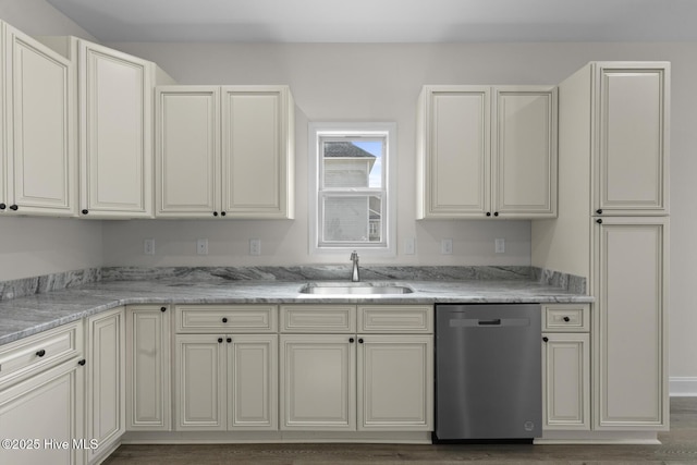 kitchen with a sink, light stone countertops, and stainless steel dishwasher