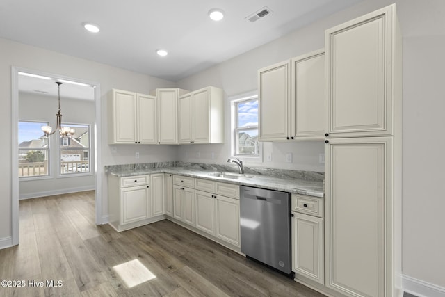 kitchen with baseboards, recessed lighting, a sink, dishwasher, and light wood-type flooring