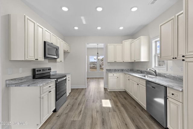 kitchen with a sink, light wood-style flooring, recessed lighting, and stainless steel appliances