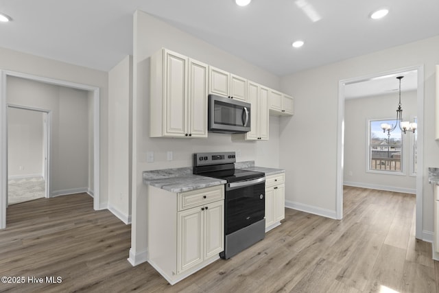 kitchen with light wood-style flooring, recessed lighting, appliances with stainless steel finishes, baseboards, and a chandelier